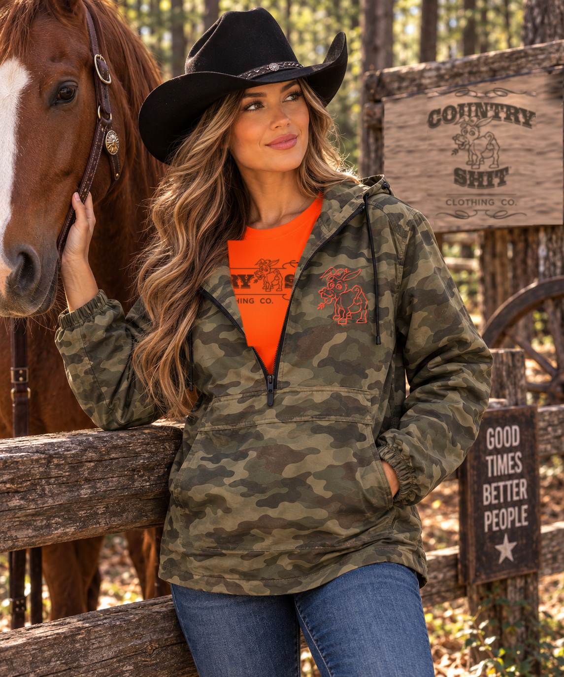 Woman wearing the camo anorak with embroidered orange donkey